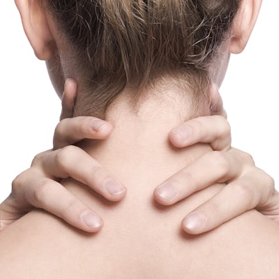 woman's fingers wrapped around the back of her neck