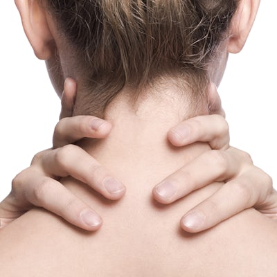 woman's fingers wrapped around the back of her neck