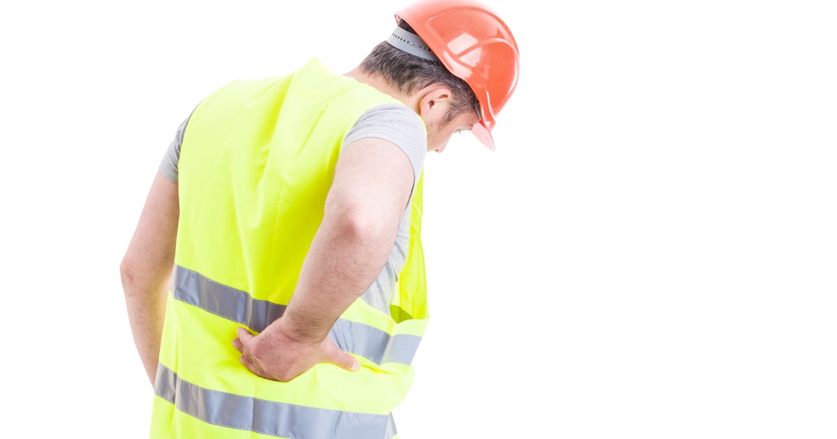 construction worker from behind right hand holding lower back