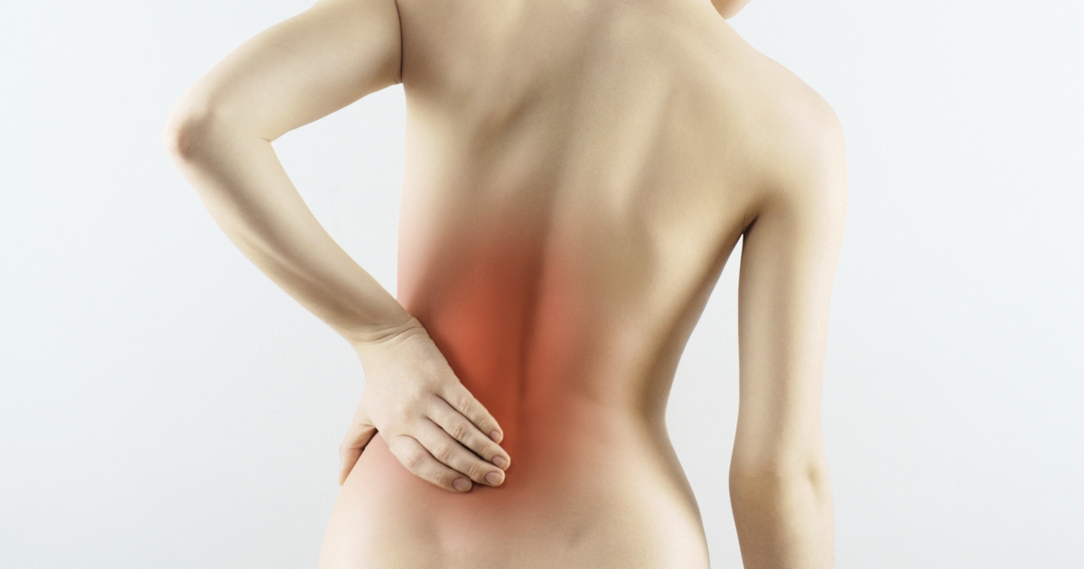 The image shows a person from the back, holding their lower back with a red highlight indicating pain or discomfort.