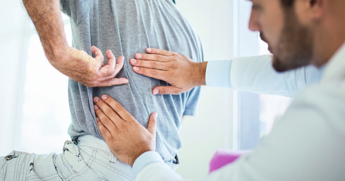 doctor evaluating patient's back pain