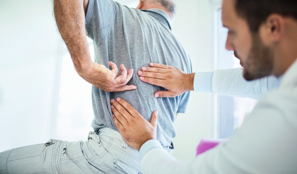 doctor evaluating patient's back pain