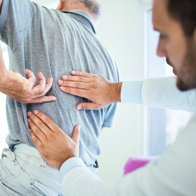 doctor evaluating patient's back pain