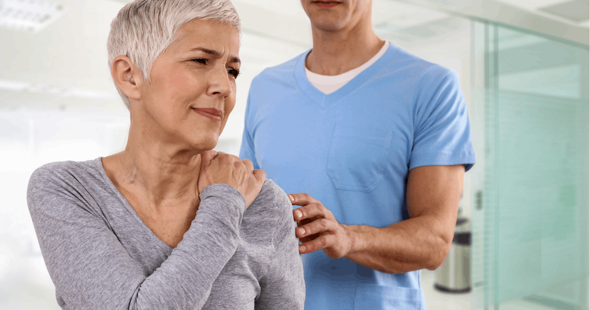 Mature Woman suffering from back pain during medic