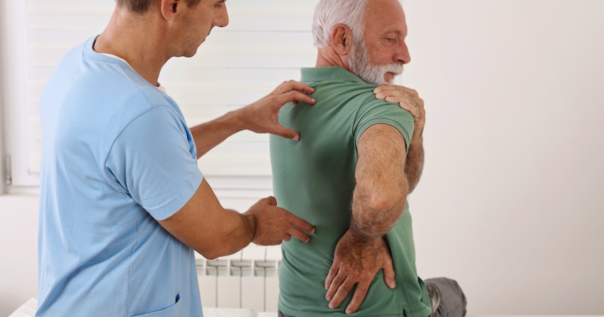 Senior man with back pain. Spine physical therapis