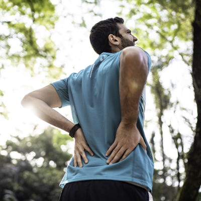 Sportsman feeling backache at a park