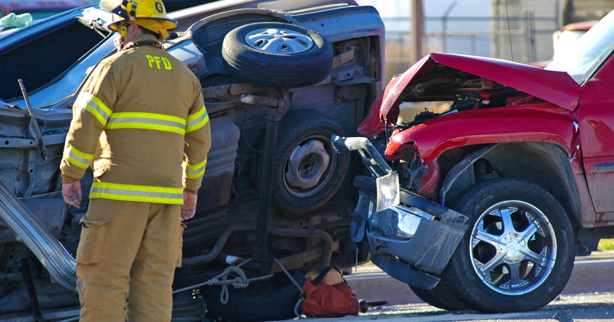 Fire fighter stands by aftermath of car crash