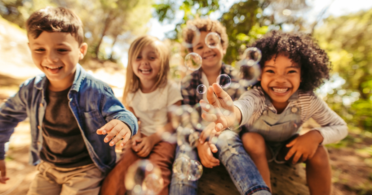 Group of children playing with soap bubbles