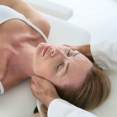 young brunette white female chiropractic adjustment