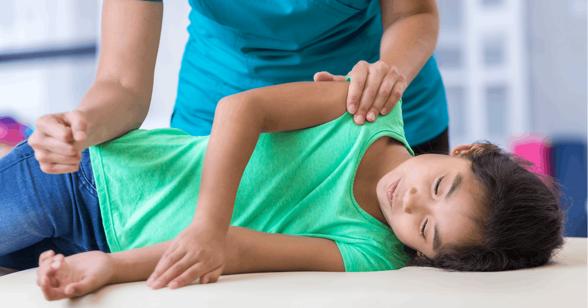 Chiropractor with young patient