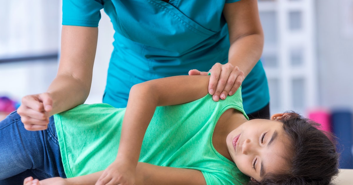 Chiropractor with young patient