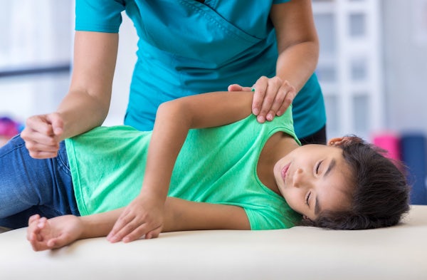 Chiropractor with young patient