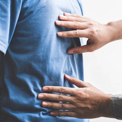 Doctor checking patient with spine to determine th