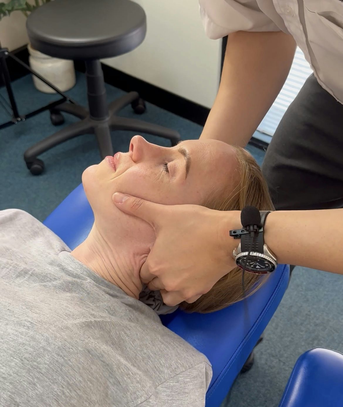 Chiropractor performing a neck adjustment on a patient during a chiropractic treatment session to alleviate neck pain and improve spinal health