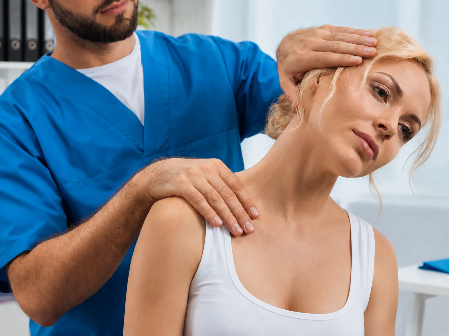 Chiropractor assessing a patient's neck and shoulder for cervical radiculopathy and nerve-related arm pain in Joondalup