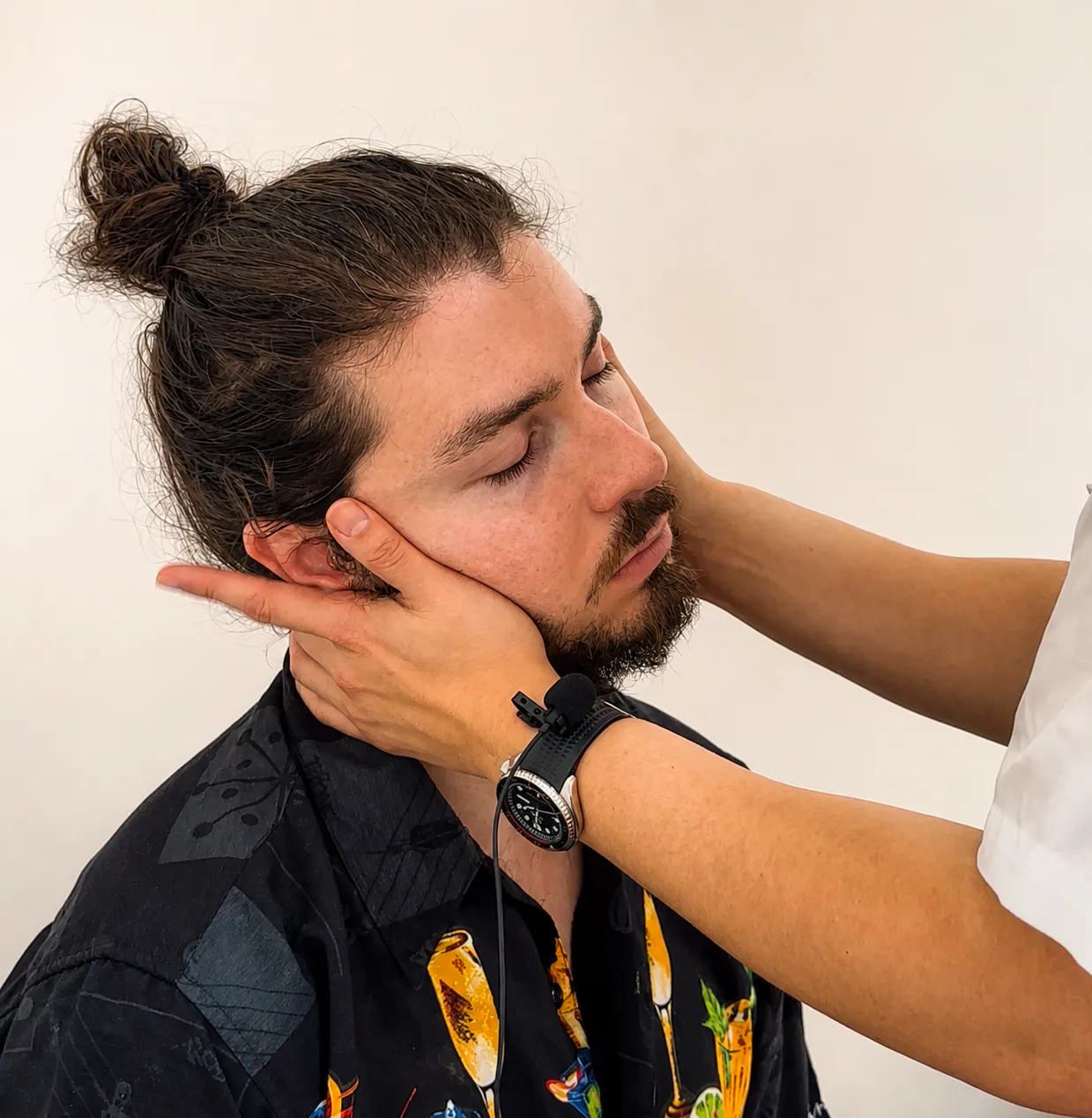 Chiropractor supporting a patient's neck during a headache and neck assessment in Joondalup