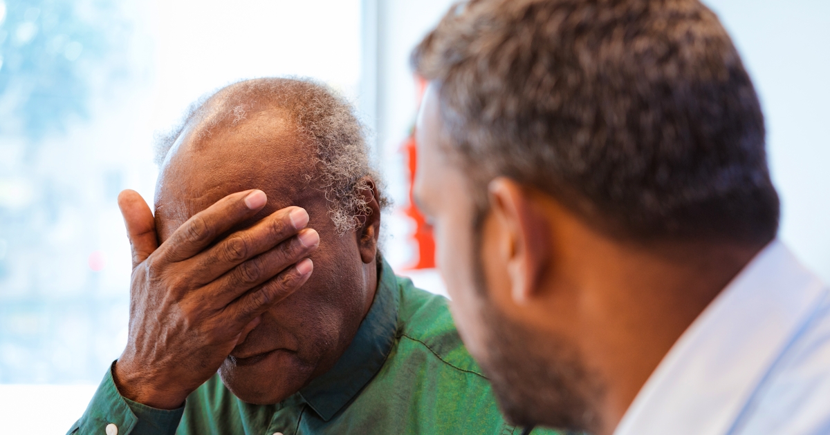 Doctor giving bad news to senior male patient