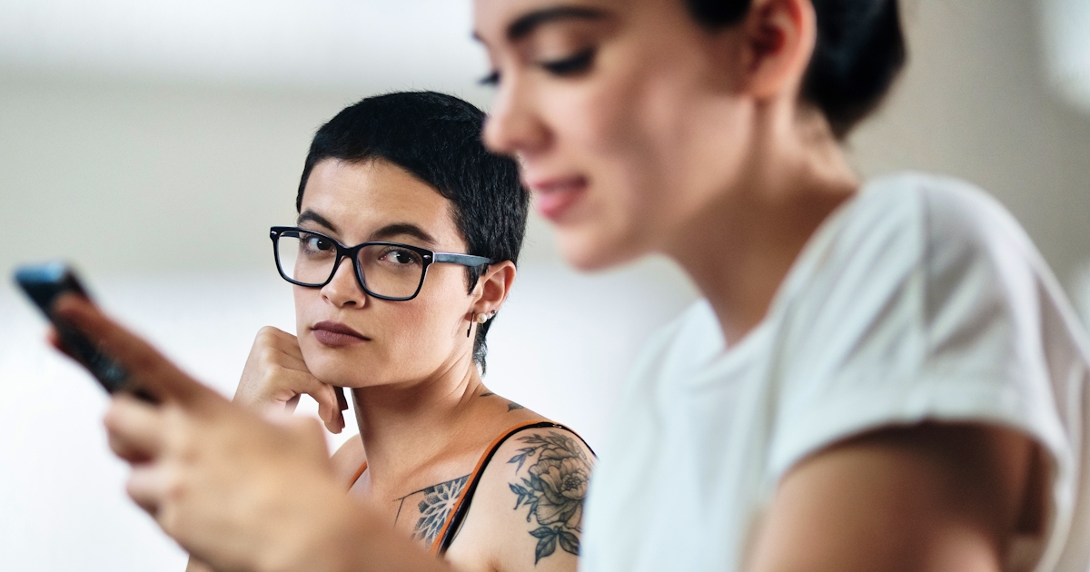 Jealous Lesbian Woman Looking at Partner Messaging
