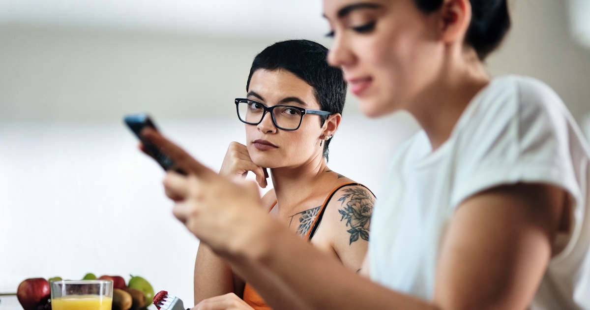Jealous Lesbian Woman Looking at Partner Messaging