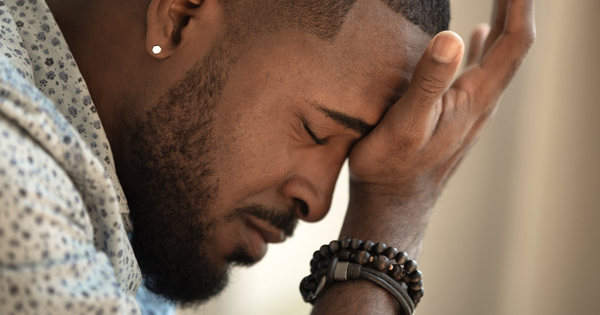 Upset stressed young african american man coping w