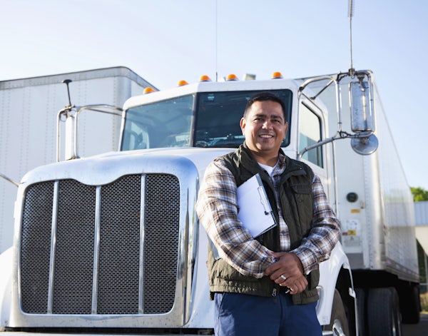 Hispanic truck driver with clipboard