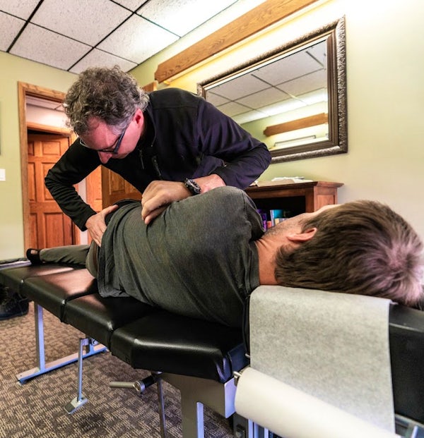 Dr. Cole McMillan performs back adjustment