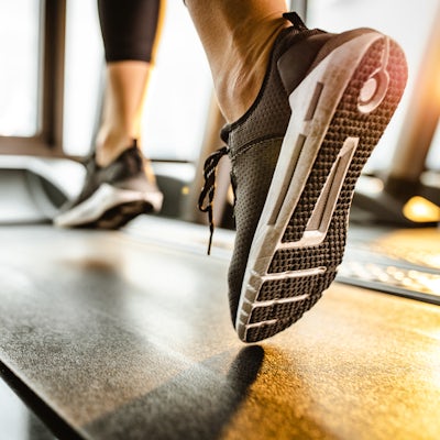Close up of unrecognizable athlete running on a tr