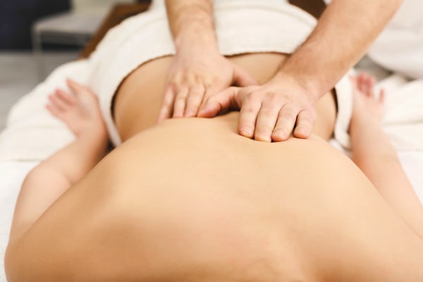 up close female bare back getting massage male massage therapist