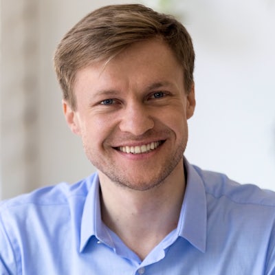 Head shot portrait of smiling confident businessma