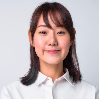 Portrait of beautiful Asian businesswoman against