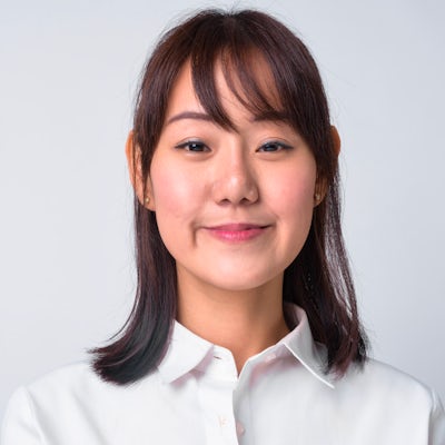 Portrait of beautiful Asian businesswoman against 