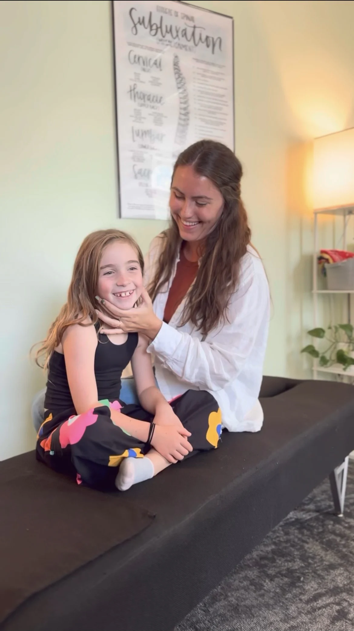 Dr. Simon performing chiropractic care on a young child.