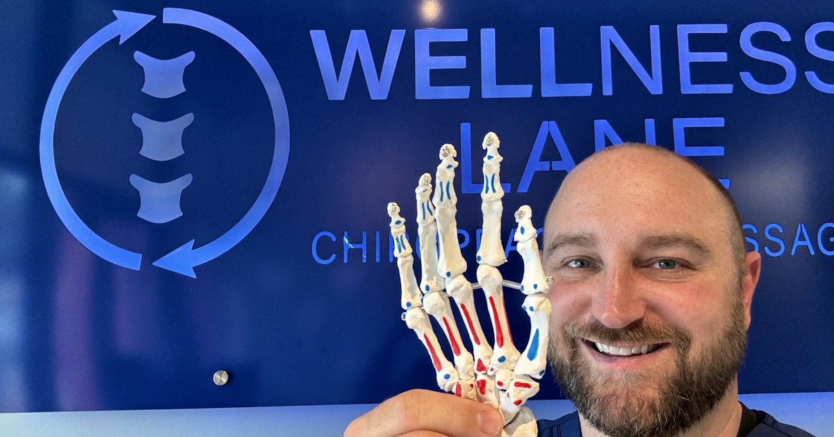 Dr Brent Smarinsky of Wellness Lane Chiropractic with a wrist model