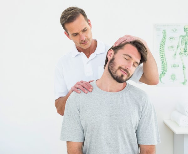 fit handsome man seated position getting chiropractic adjustment male chiropractor doctor