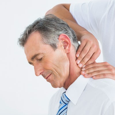 up close left side face of senior male chiropractic adjustment male chiropractor