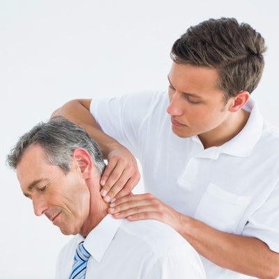 up close left side face of senior male chiropractic adjustment male chiropractor
