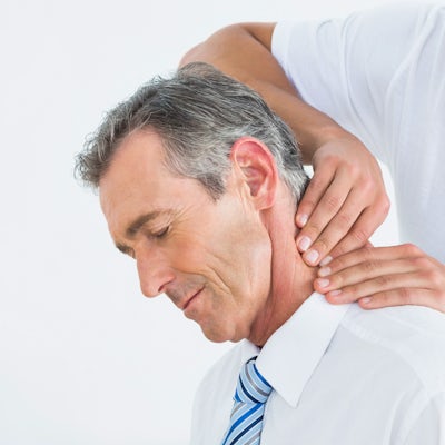 up close left side face of senior male chiropractic adjustment male chiropractor