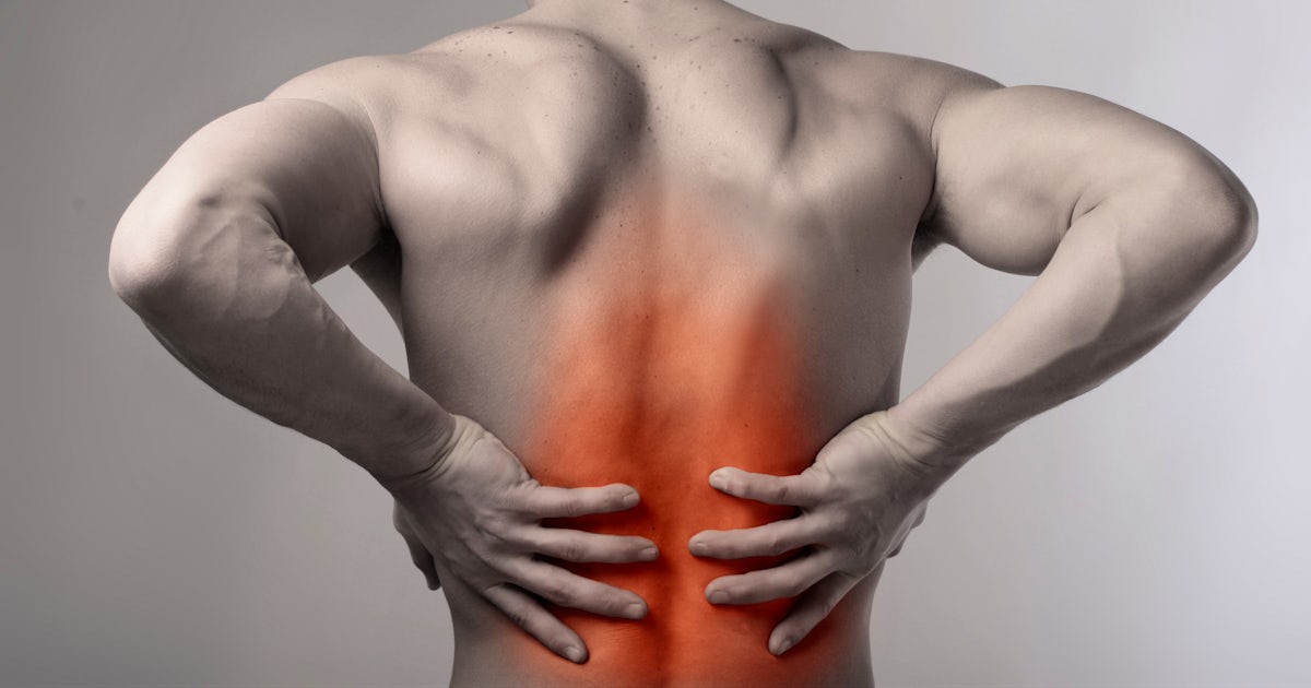 black and white back of upper half of muscular male with low back pain glowing red