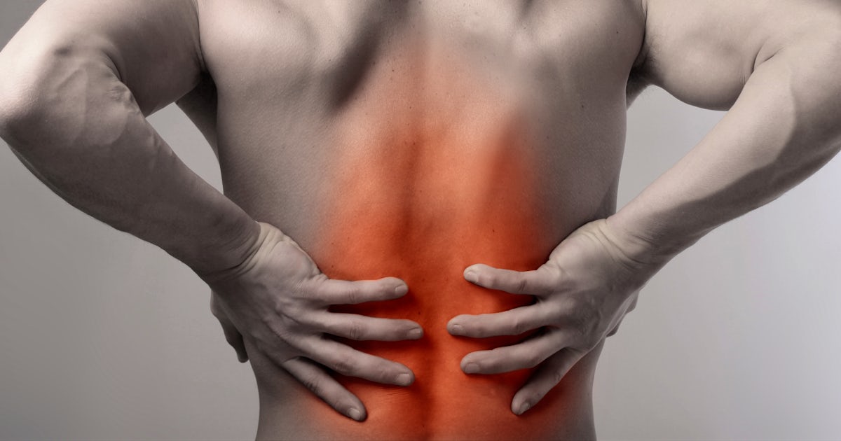 black and white back of upper half of muscular male with low back pain glowing red