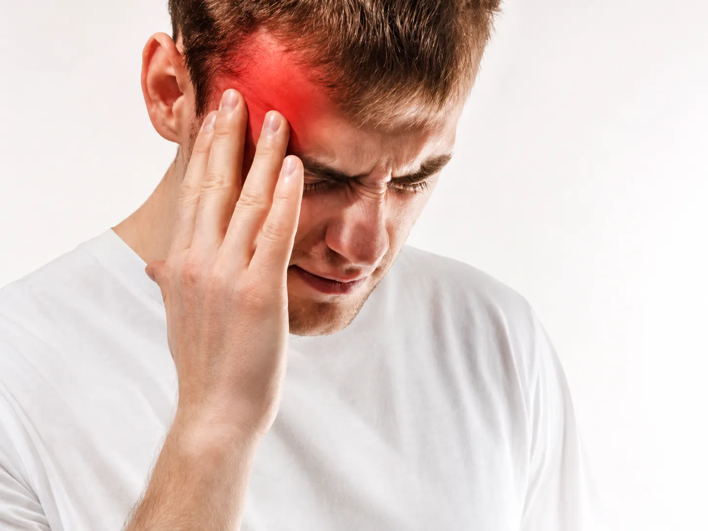 Man holding his temple with migraine headache pain