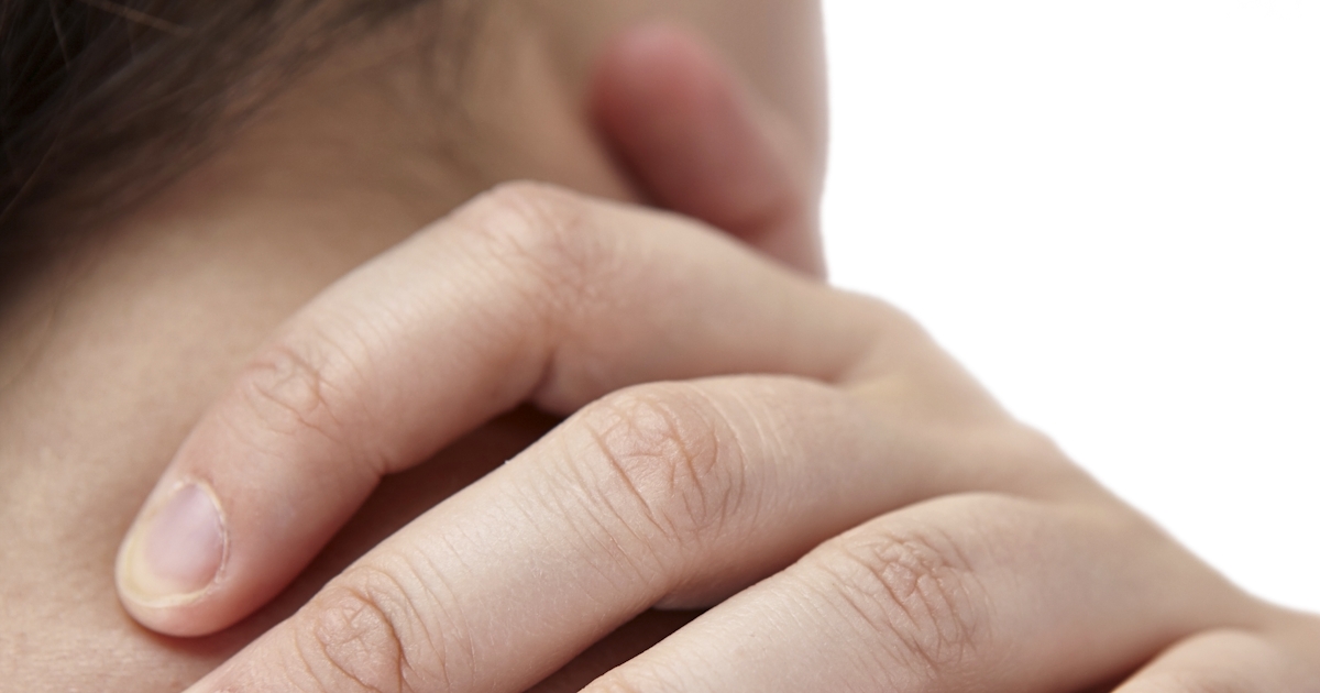 extreme closeup of fingers on person's shoulder