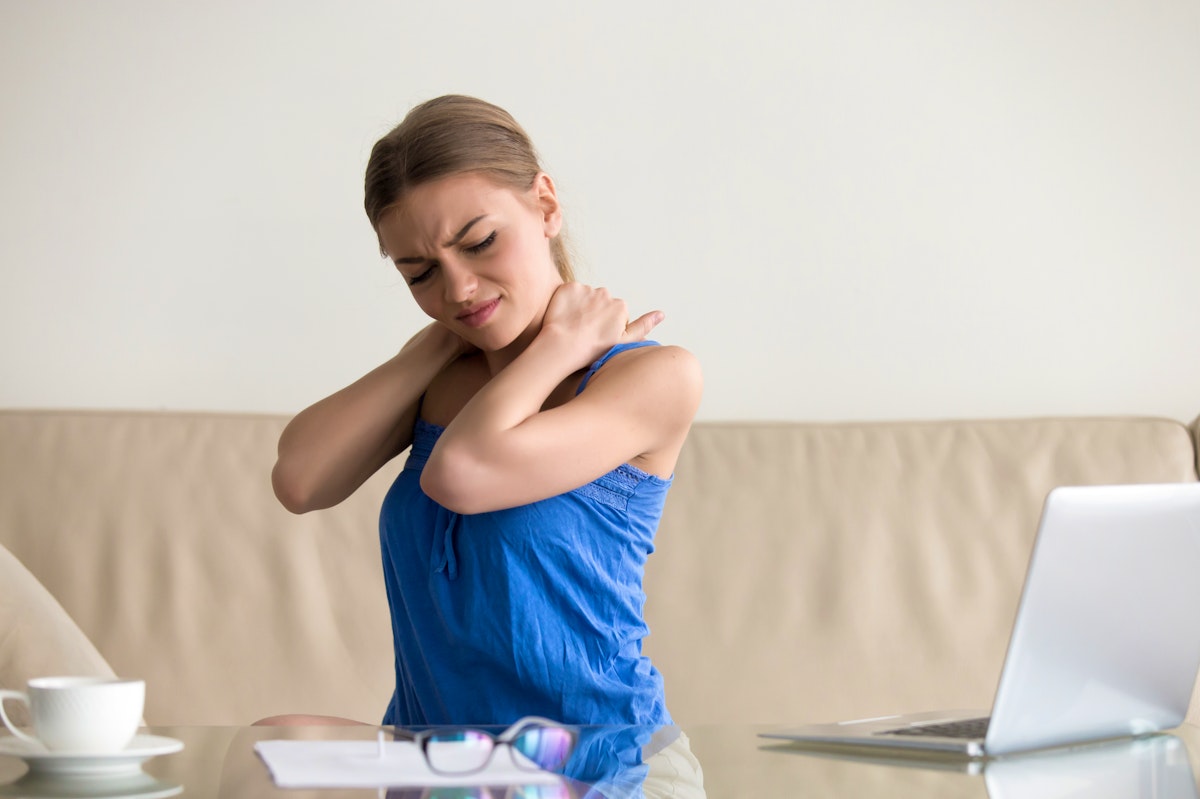 A woman tries to relieve neck pain