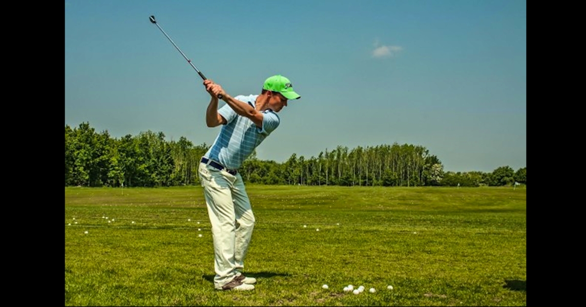 man in a green hat an off white pants practicing summer sports safety while golfing
