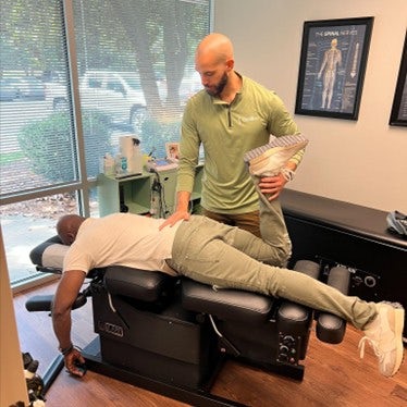 Dr. Kyle performing an adjustment on a long-time patient