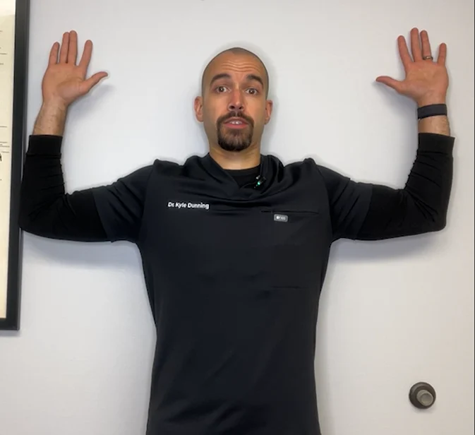 dr. dunning performing the wall angel stretch