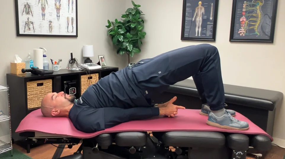 dr. dunning performing an optional step three of the glute bridge stretch