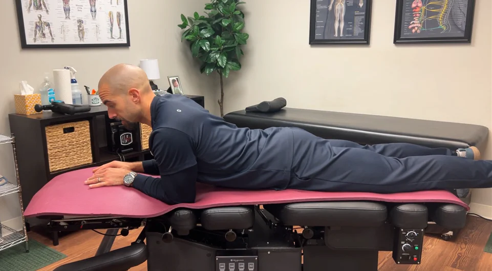 dr. dunning performing the initial position of the cobra pose stretch