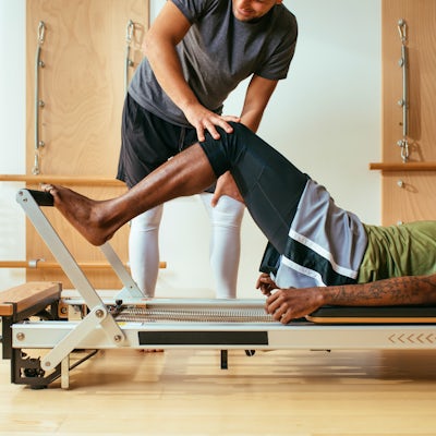 Sportsmen Exercising at Reformer Pilates Studio