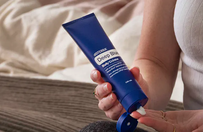doTERRA Deep Blue Rub cream being applied from the tube