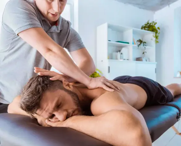 Chiropractor providing manual treatment to a patient with spinal arthritis-related back stiffness and pain